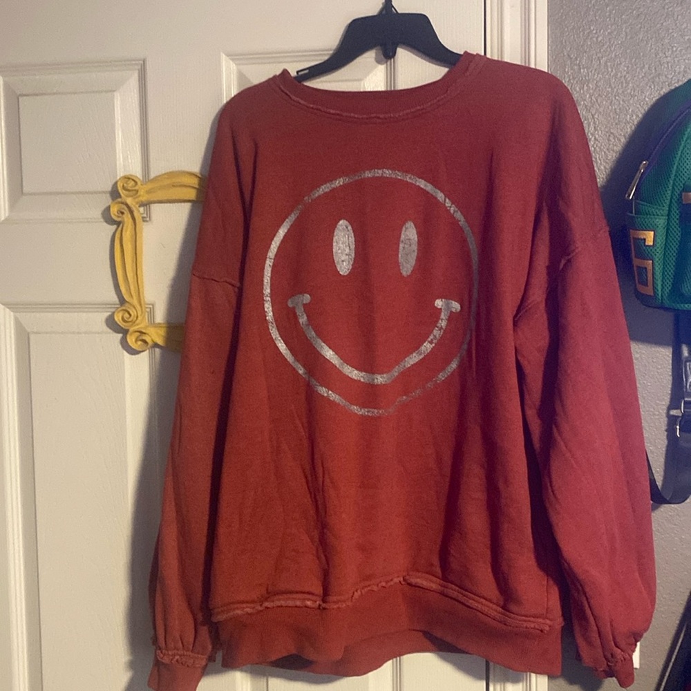 Never worn sweatshirt. Rust red color. With a front pocket!